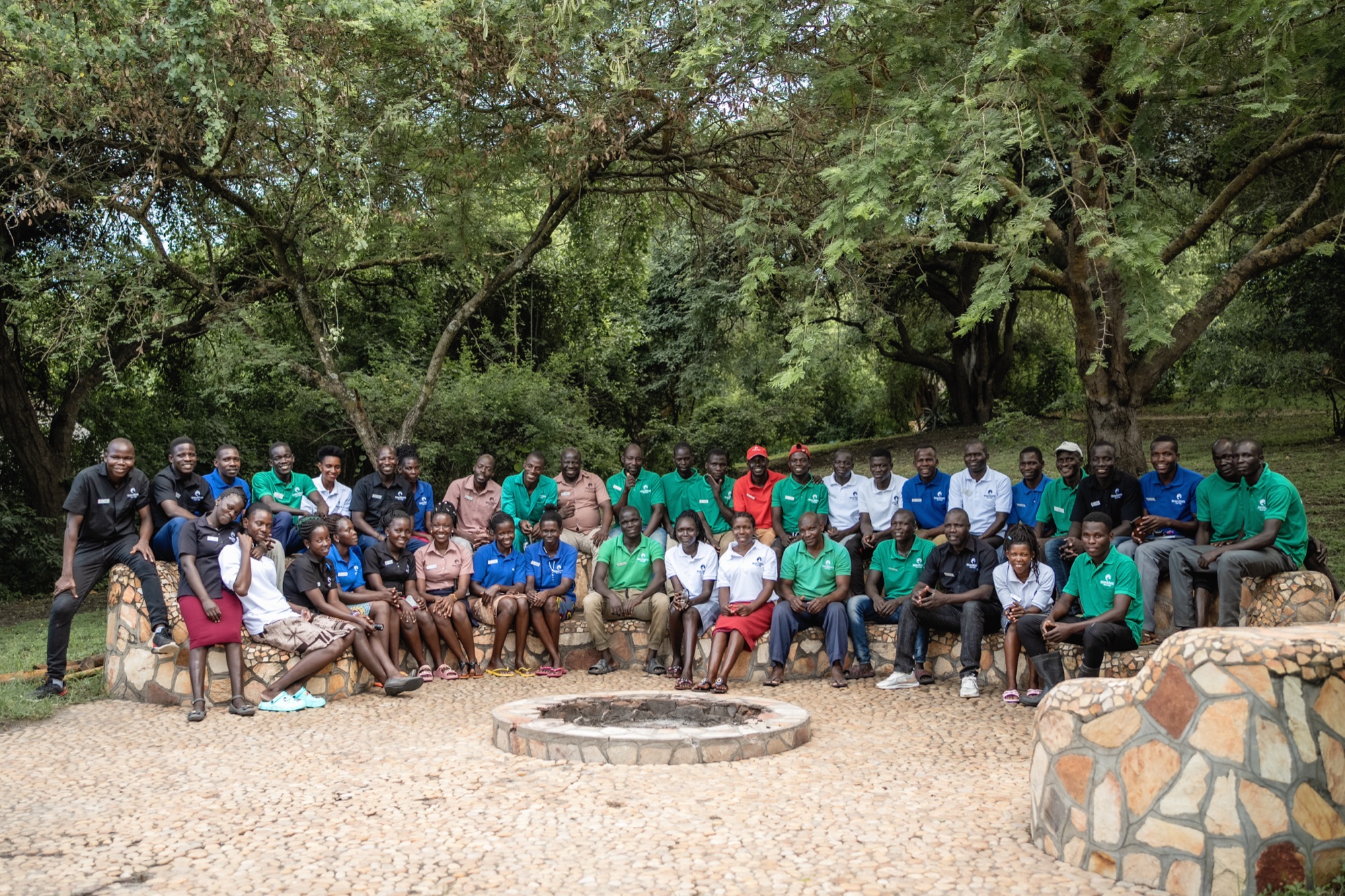 The Murchison River Lodge team, around forty of them, on the stone benches around the fire pit